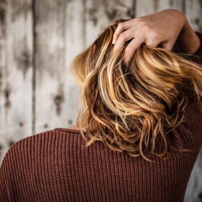 hair growth improvements with hair club | image with girl raking her hands through new hair growth